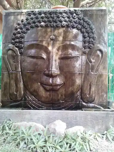 Carved Buddha stone wall feature at Just Relax Thai Spa